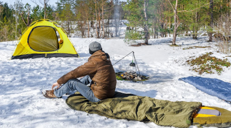 Man winter camping in the snow 