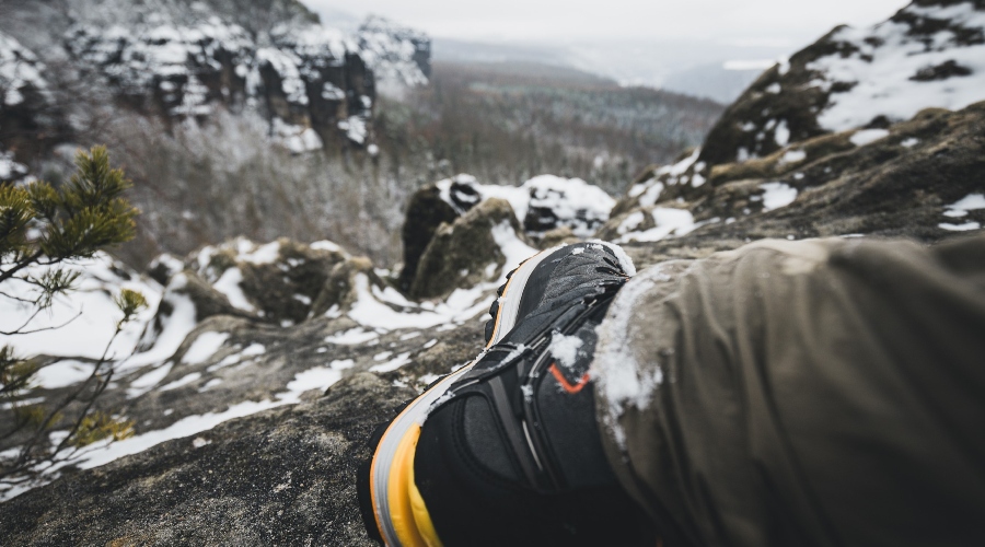 Hiking boot on the snowy mountains 
